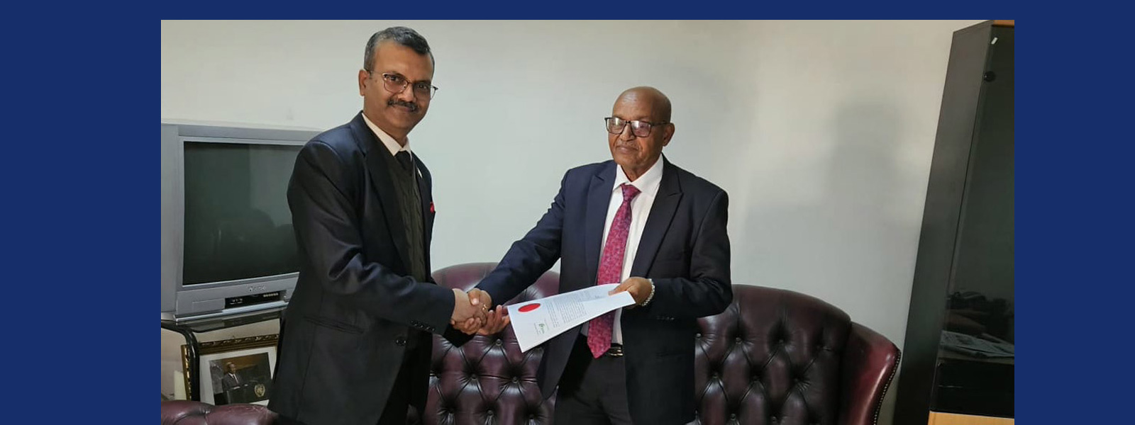 Ambassador Raj Kamal presents a copy of his Letter of Credence to Eritrea's Chief of Protocol